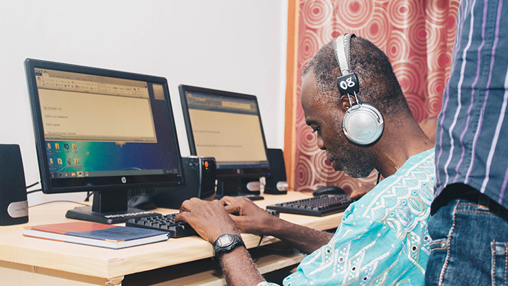 Tech Era training a visually impaired teacher to use a computer